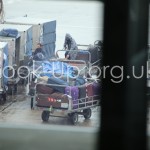 Luggage being offloded from ULDs to be manually loaded into rear hold